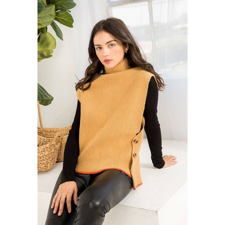 Camel knit sweater vest with high neckline, oversized arm openings, side button detail and orange contrast edging.