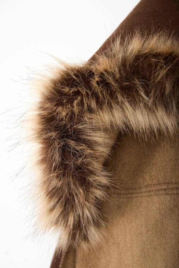 Close-up of faux fur trim on chocolate and camel hooded wrap