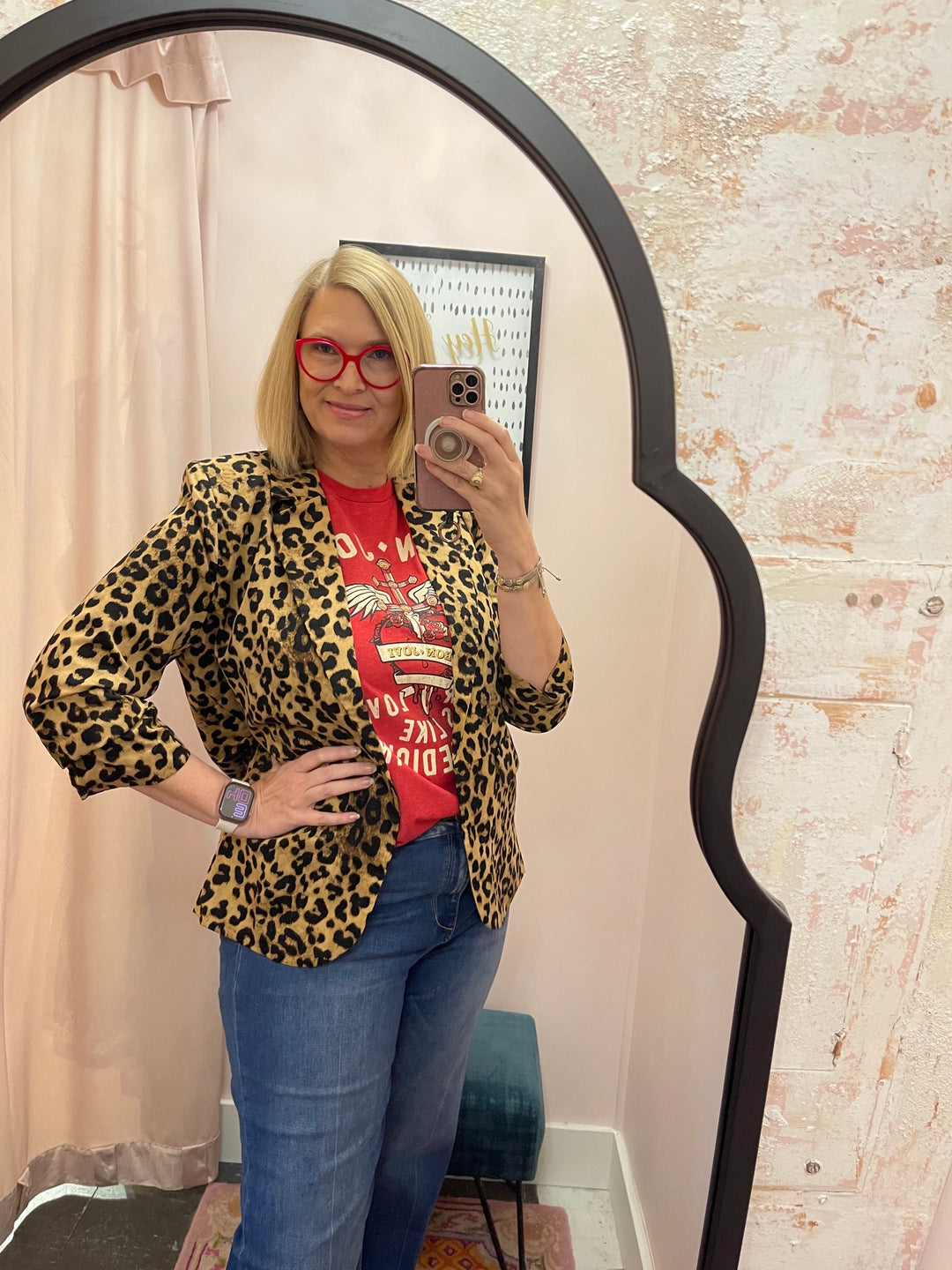 Woman wearing Bon Jovi Bad Medicine red graphic tee with leopard blazer and blue jeans