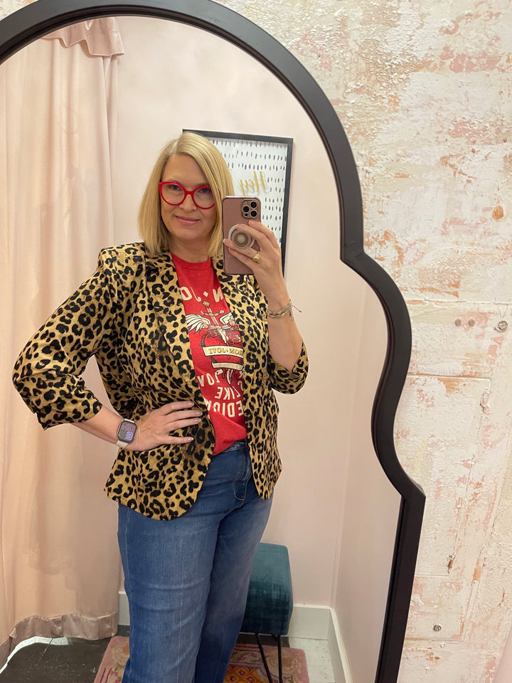 Woman wearing Bon Jovi Bad Medicine red graphic tee with leopard blazer and blue jeans