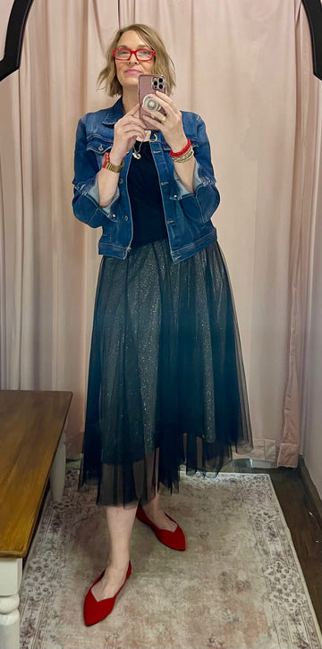 a woman in a black shirt and a black skirt