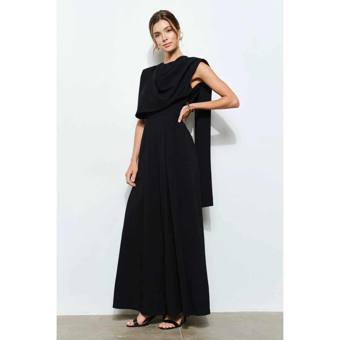 Black sleeveless wide-leg jumpsuit with dramatic draped scarf detail and elegant floor-length silhouette