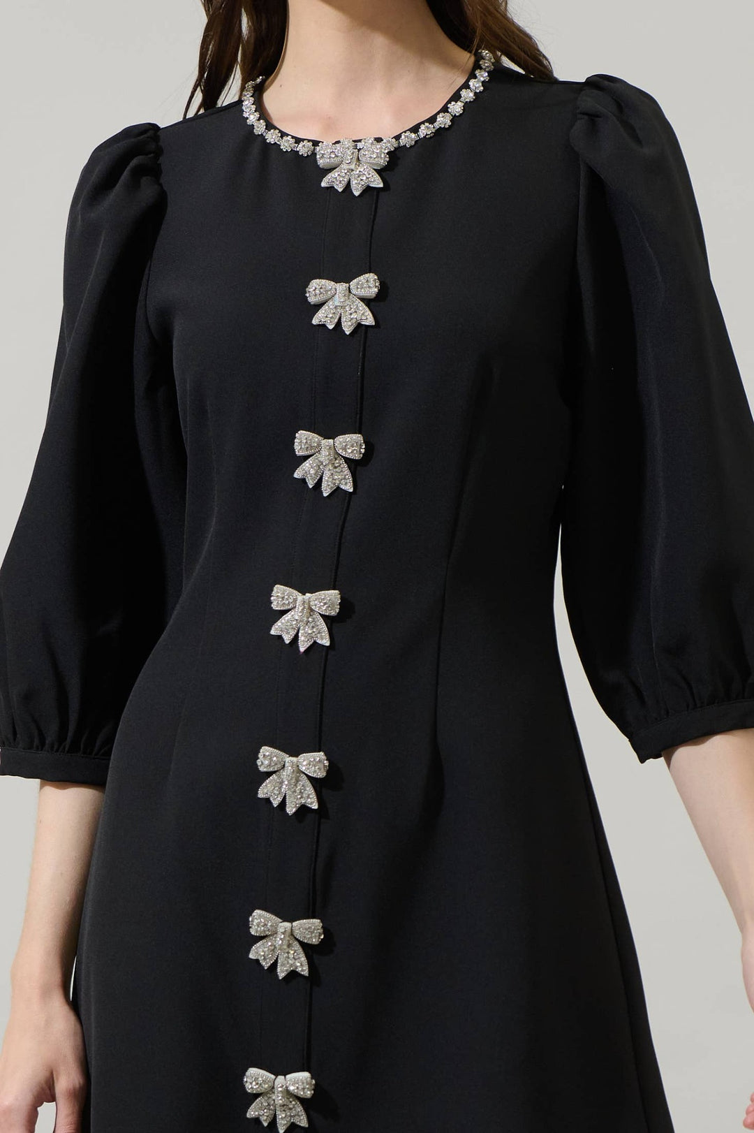 Bow Down black A-line mini dress with rhinestone bows and puff sleeves