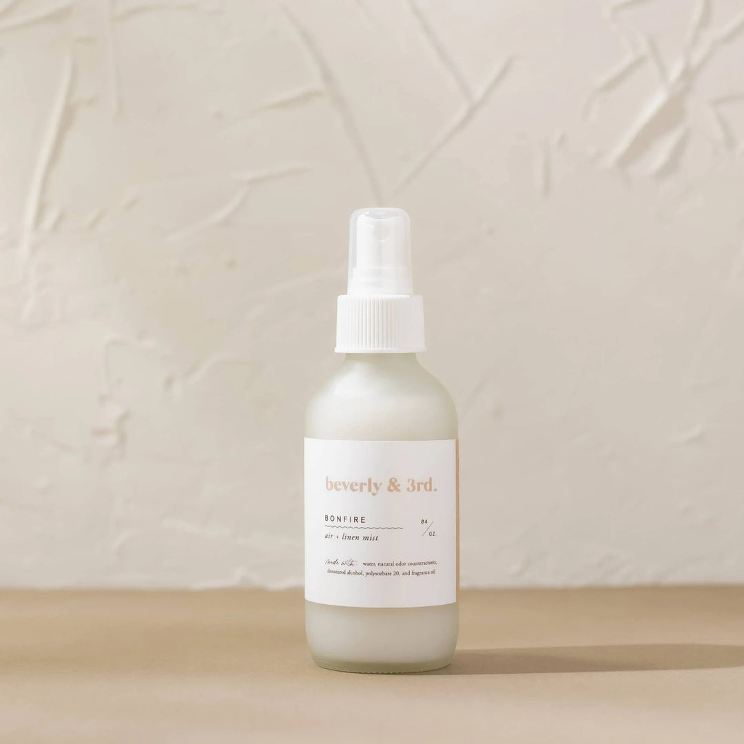 Bonfire Air + Linen Mist in frosted glass bottle with clove, smoke and vanilla fragrance notes