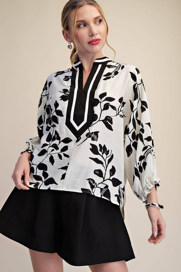 Ink & Ivory black botanical print blouse with contrast V-neck trim and ruffled long sleeves