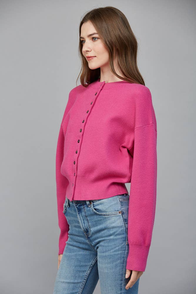 Side view of Pop of Pink Cardigan showing its relaxed silhouette, dropped shoulder and ribbed hem.