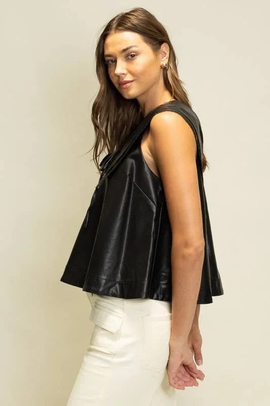 Side view of Rebel Romance black faux leather top showing the sleeveless cut and easy flared silhouette.