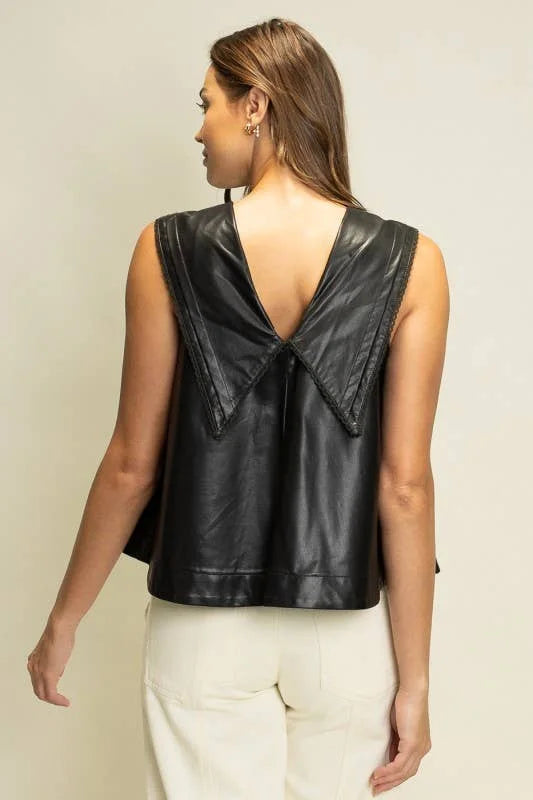 Back view of black faux leather sleeveless top featuring a deep V-back and oversized pointed sailor collar.