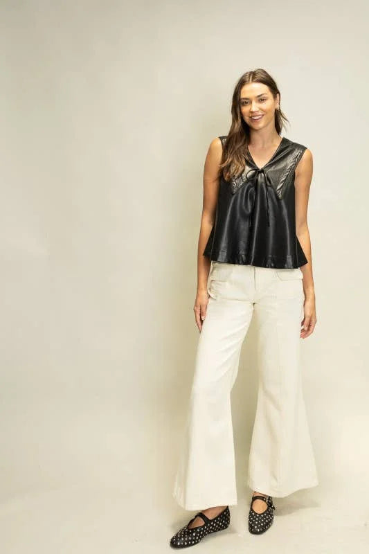 Rebel Romance black faux leather top styled with ivory wide leg pants and black flats for a modern statement look.