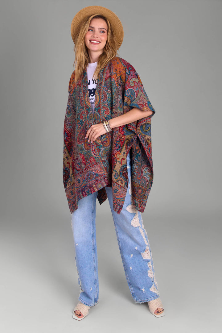 SAACHI Regal Rococo poncho styled with distressed denim