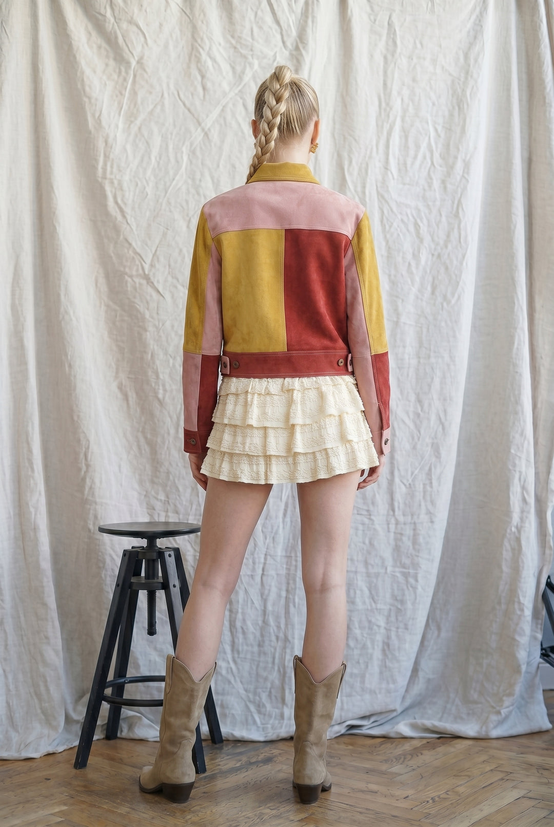 Back view of Retro Revival Colorblock Suede Jacket featuring mustard, rust and blush pink suede patchwork and cropped hem.