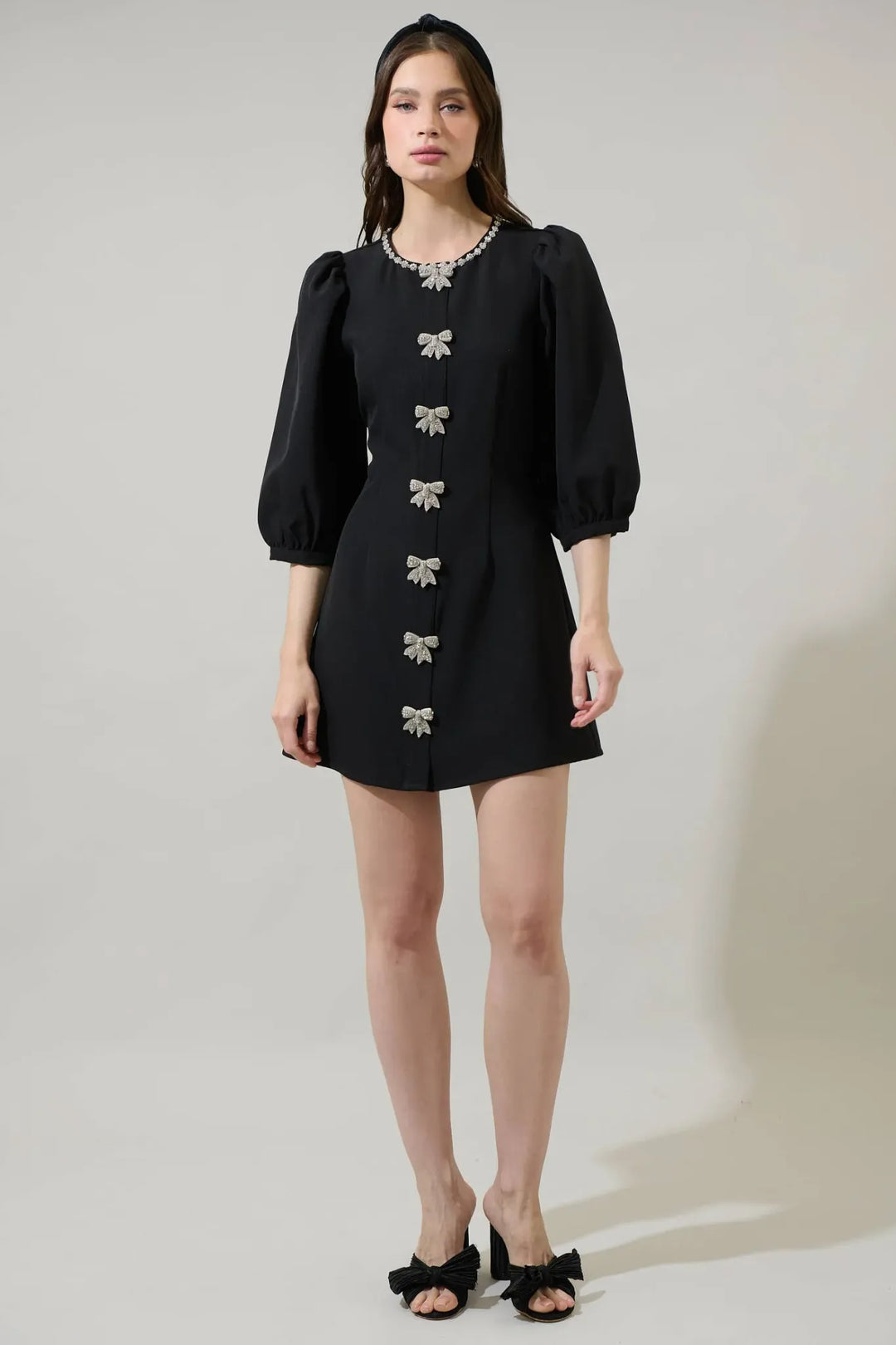 Black A-line mini dress with rhinestone bow details full length view
