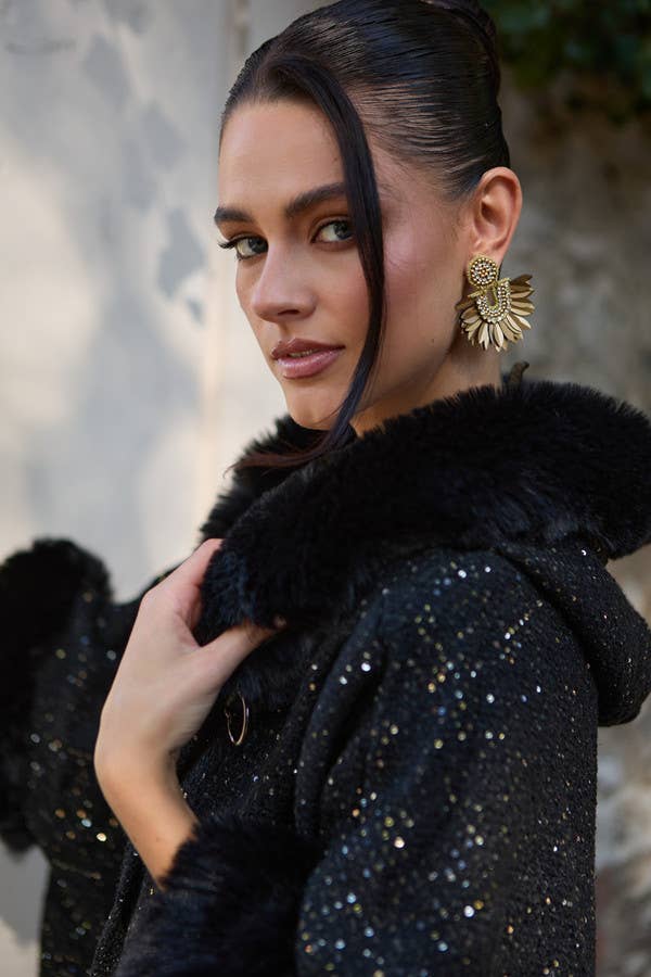 Close-up of black faux fur hood on sequin SAACHI cape