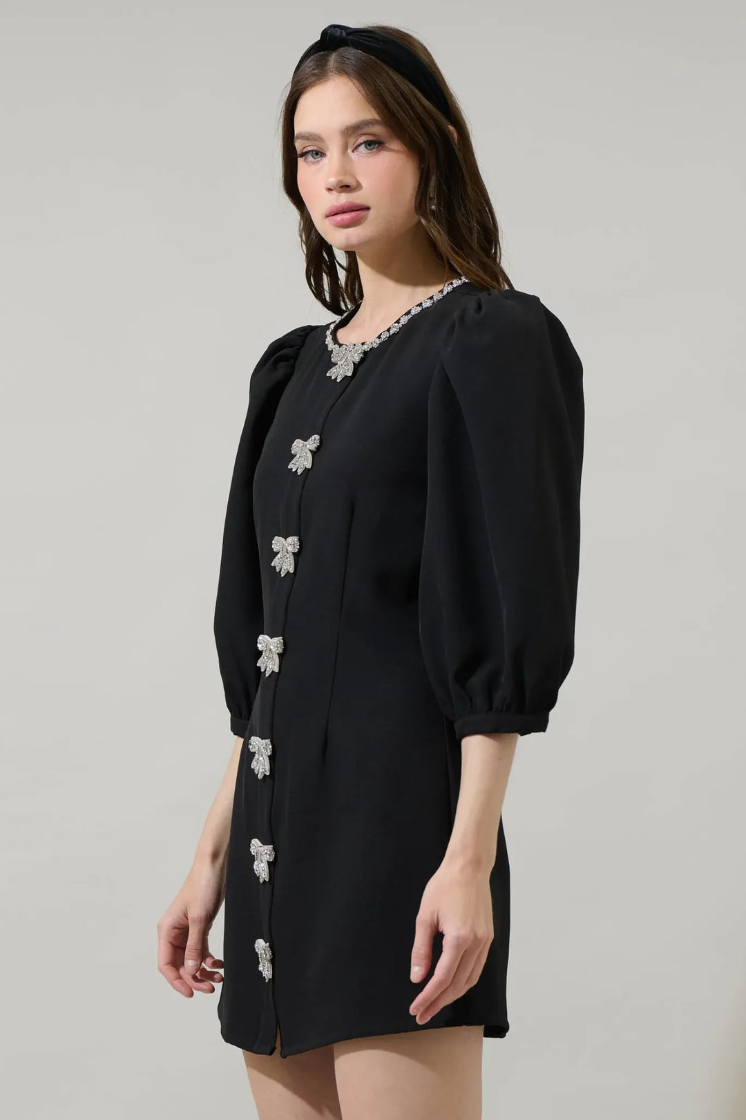 Black rhinestone bow mini dress with three-quarter puff sleeves side view