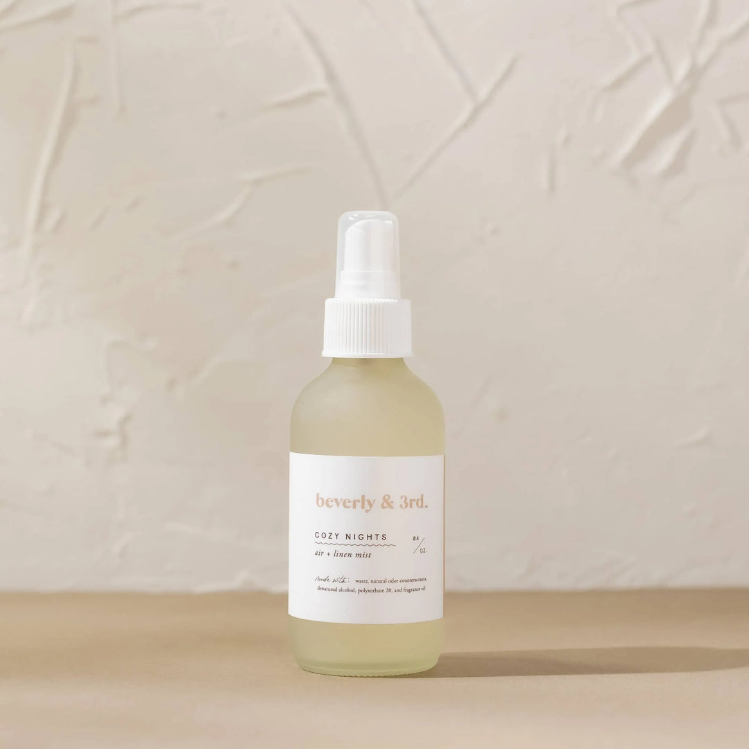 Cozy Nights Air + Linen Mist in 4 oz frosted glass bottle with spruce, cedar, fir and raspberry fragrance notes.