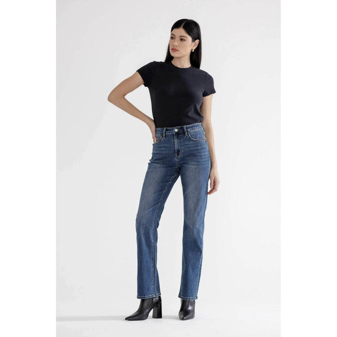 Model wearing Mica Denim high rise straight leg jeans in DoYou Blue