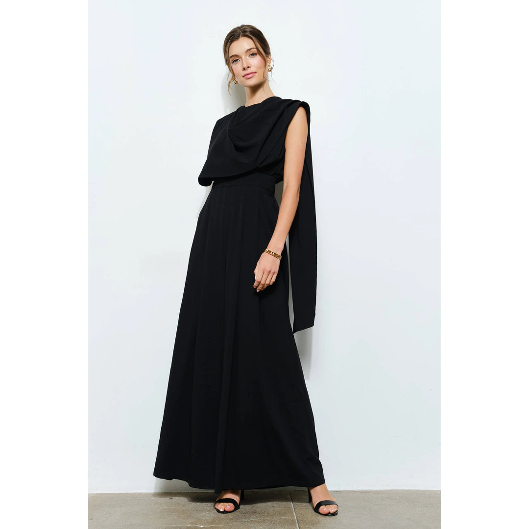 Women’s black wide-leg jumpsuit featuring an asymmetrical draped scarf neckline and sleeveless design
