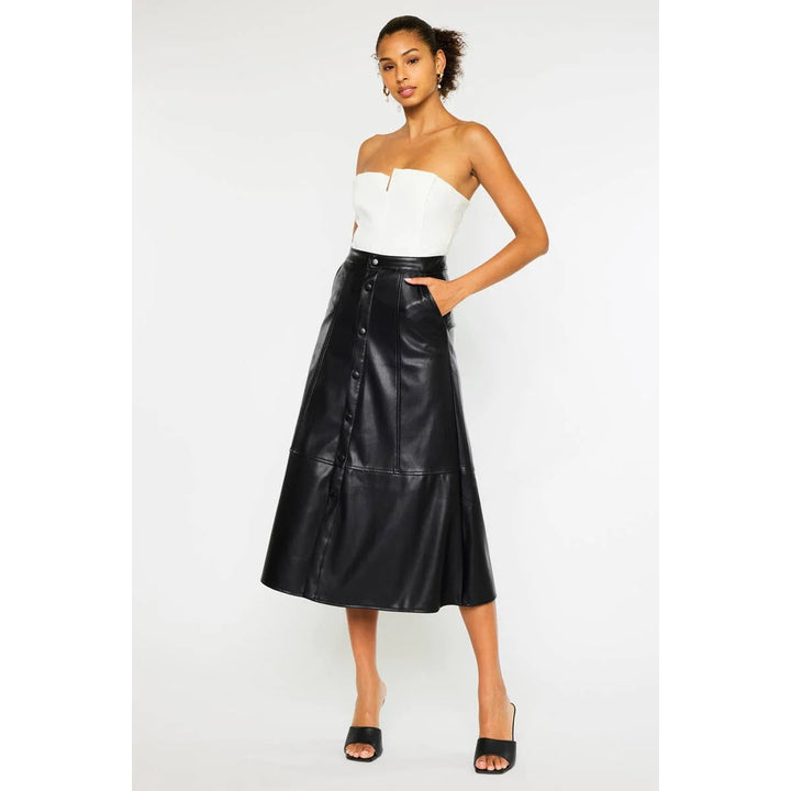 Rebel Luxe faux leather midi skirt in black showing front snap buttons, side pockets and high-rise waist