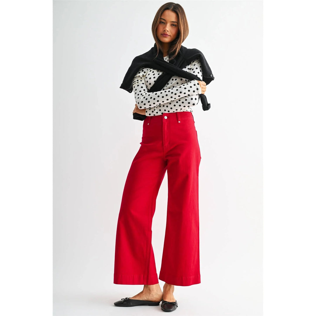 Front view of Red Hot wide leg jeans styled with a polka dot top and black flats.