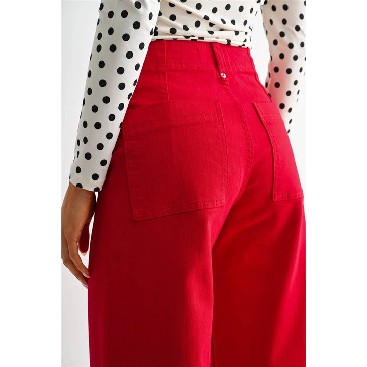 Close-up of Red Hot red jeans showing the back patch pocket and waistband.