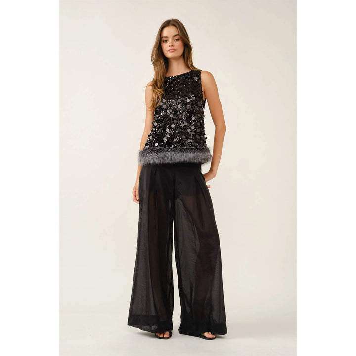 Fur the Drama sequin top styled with black wide-leg pants for a party look