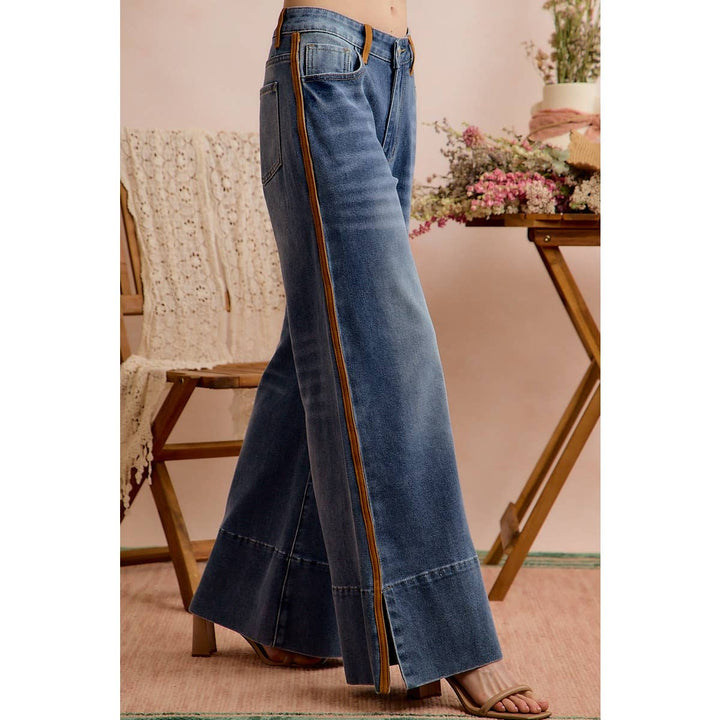 Full side view of wide leg denim jeans with cognac stripe and side slit hem